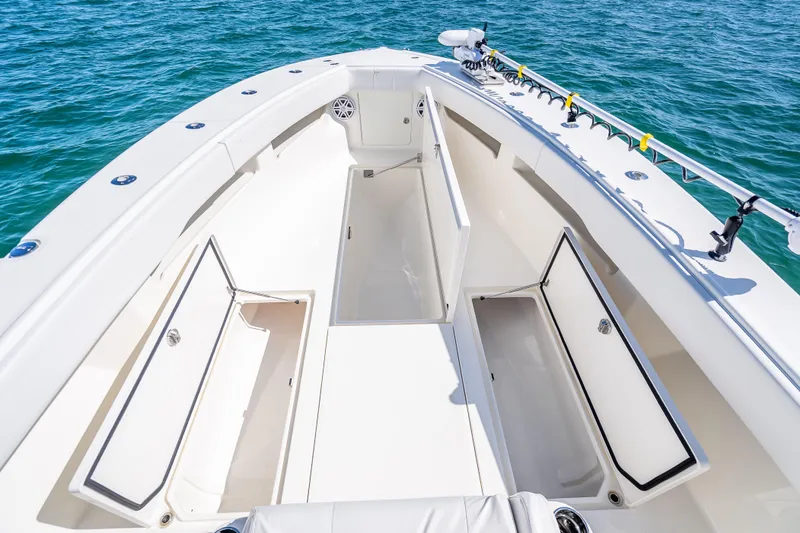  Yacht Photos Pics 2019 SeaVee 340Z boat deck with open storage compartments, surrounded by blue ocean water.