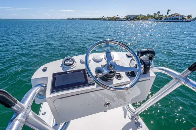  Yacht Photos Pics 2019 SeaVee 340Z boat helm with steering wheel and navigation equipment on open water.