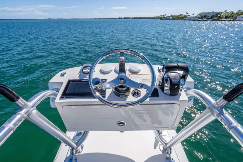 Yacht Photos Pics 2019 SeaVee 340Z boat helm with steering wheel and controls on open water.