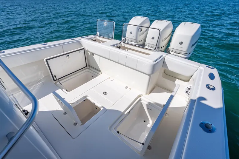  Yacht Photos Pics 2019 SeaVee 340Z boat with open storage compartments and triple outboard engines on blue water.