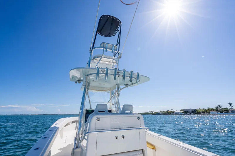  Yacht Photos Pics 2019 SeaVee 340Z boat on sunny ocean, clear blue sky, and distant shoreline.