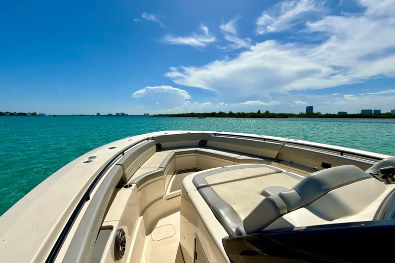 Yacht Photos Pics 2021 Scout 420 LXF boat cruising on clear blue water under a sunny sky.