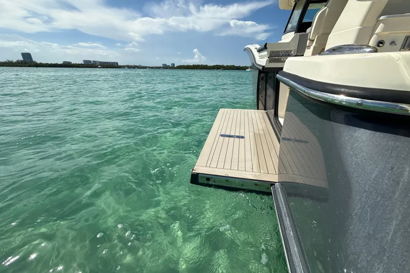  Yacht Photos Pics 2021 Scout 420 LXF yacht with swim platform on clear turquoise water.