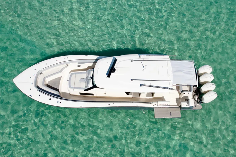  Yacht Photos Pics Aerial view of 2021 Scout 420 LXF boat on clear turquoise water.