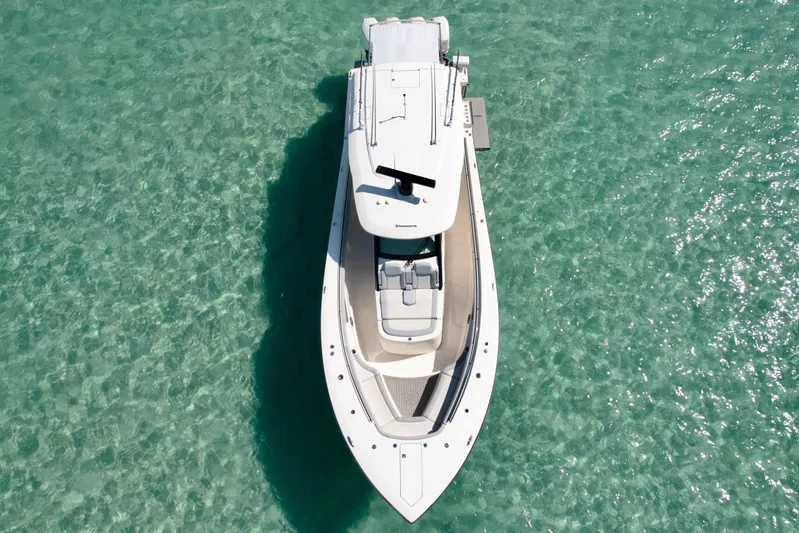  Yacht Photos Pics Overhead view of 2021 Scout 420 LXF boat on clear turquoise water.