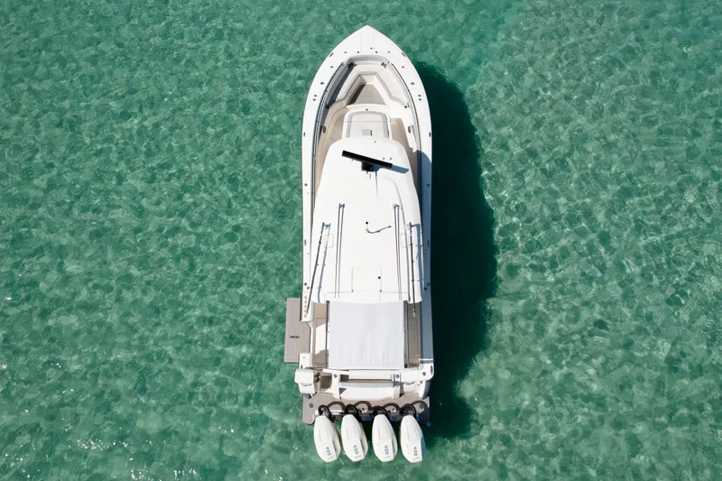  Yacht Photos Pics Aerial view of 2021 Scout 420 LXF boat on clear turquoise water.