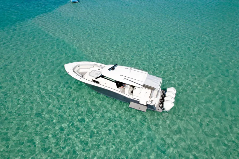 Yacht Photos Pics 2021 Scout 420 LXF boat on clear turquoise water, aerial view.