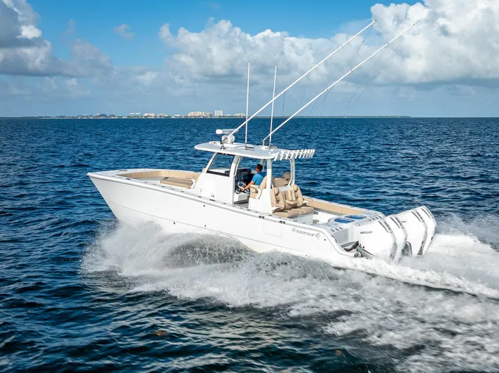  Yacht Photos Pics 2025 Freeman 35 boat cruising on open water under a clear blue sky.