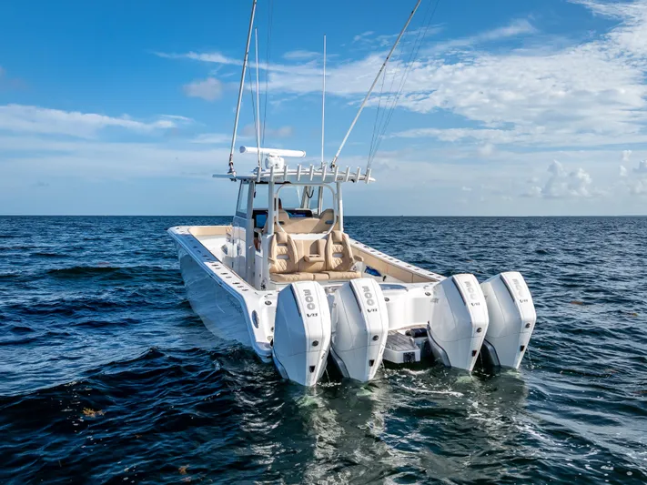  Yacht Photos Pics 2025 Freeman 35 boat with four engines cruising on open sea under blue sky.