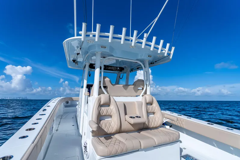 Yacht Photos Pics Freeman 35 boat, 2025 model, with luxurious seating on open ocean under clear blue sky.