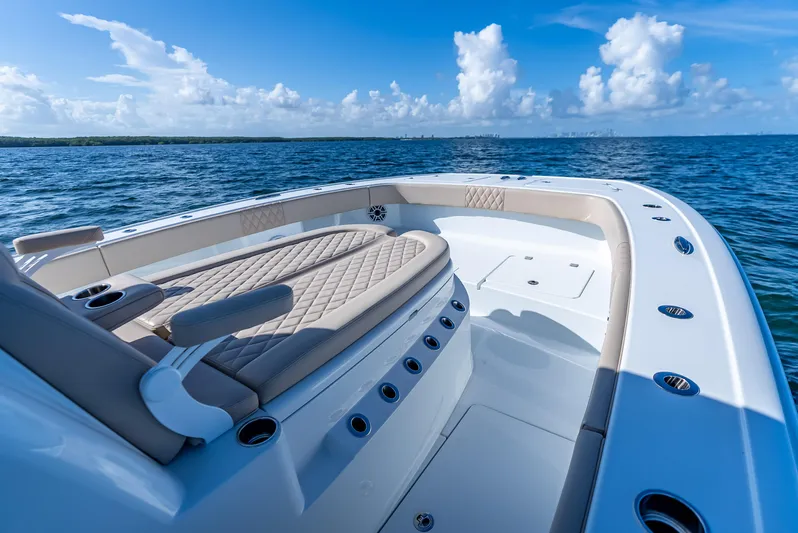  Yacht Photos Pics Luxurious 2025 Freeman 35 boat interior with cushioned seating, cruising on open blue waters.