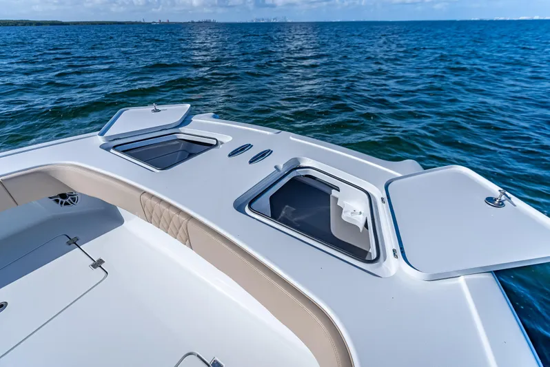  Yacht Photos Pics Freeman 35 boat deck with open storage compartments, 2025 model, on calm ocean waters.