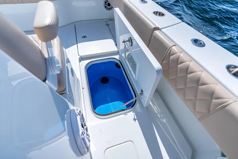  Yacht Photos Pics 2025 Freeman 35 boat interior with open storage compartment, blue interior, and quilted seating.