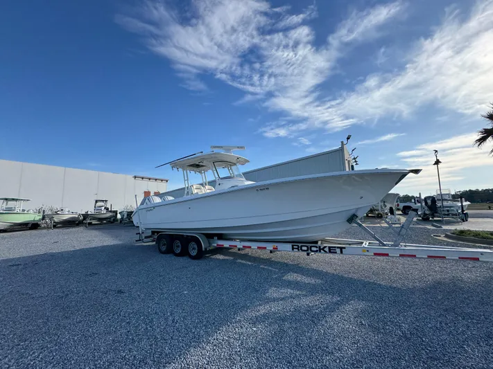  Yacht Photos Pics 2017 Edgewater 320CC boat on trailer under blue sky.
