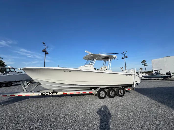  Yacht Photos Pics 2017 Edgewater 320CC boat on a Rocket trailer in a parking lot.