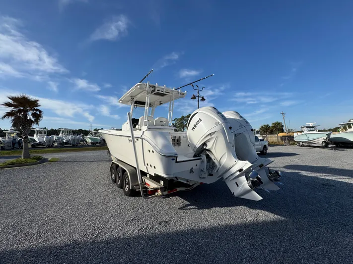  Yacht Photos Pics 2017 Edgewater 320CC boat with dual Yamaha engines on a trailer, parked outdoors.