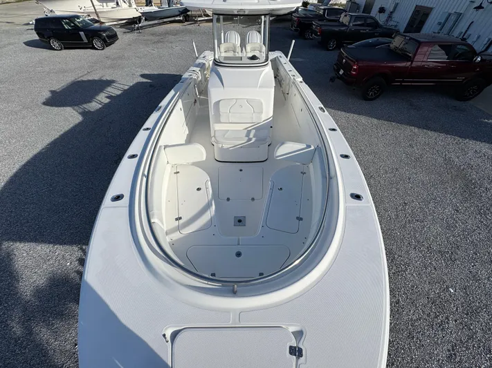  Yacht Photos Pics 2017 Edgewater 320CC boat, spacious deck, white exterior, parked on gravel lot.