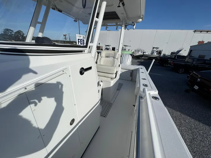  Yacht Photos Pics 2017 Edgewater 320CC boat deck with seating, docked outdoors.