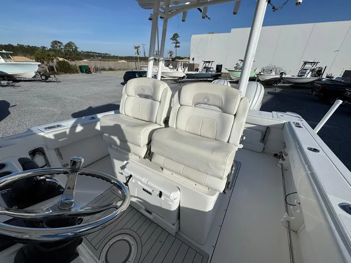  Yacht Photos Pics 2017 Edgewater 320CC boat interior with dual white seats and steering wheel.
