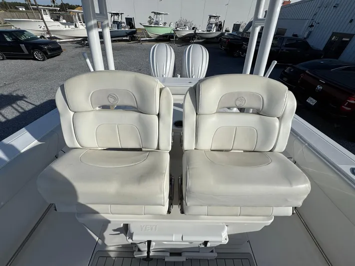  Yacht Photos Pics 2017 Edgewater 320CC boat with dual white cushioned seats, docked in a marina.