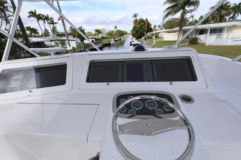  Yacht Photos Pics 2005 Viking 52 Convertible yacht helm with steering wheel and navigation displays.