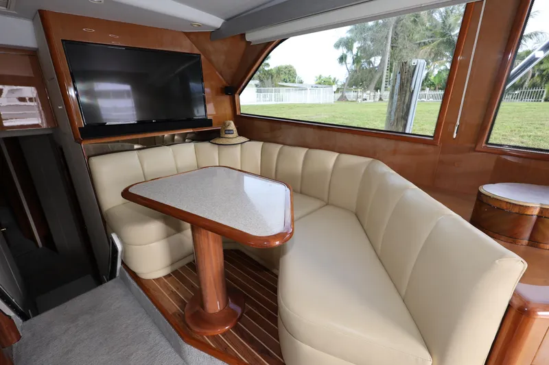  Yacht Photos Pics Luxurious interior of 2005 Viking 52 Convertible yacht with plush seating and elegant table.