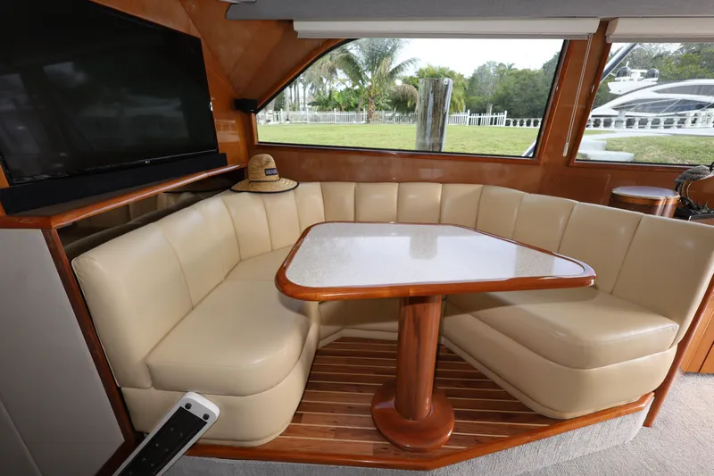  Yacht Photos Pics Luxurious interior of 2005 Viking 52 Convertible yacht with cream leather seating and wooden table.