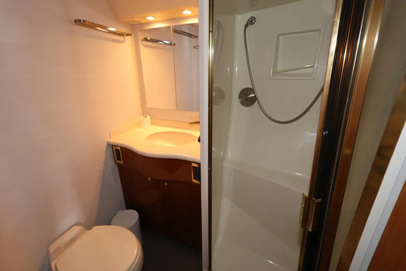  Yacht Photos Pics Bathroom interior of 2005 Viking 52 Convertible yacht, featuring shower and vanity.