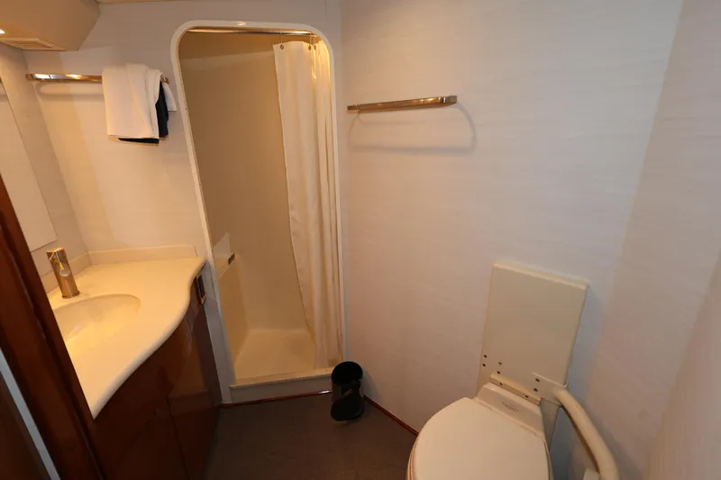  Yacht Photos Pics Bathroom interior of 2005 Viking 52 Convertible yacht, featuring shower, sink, and toilet.