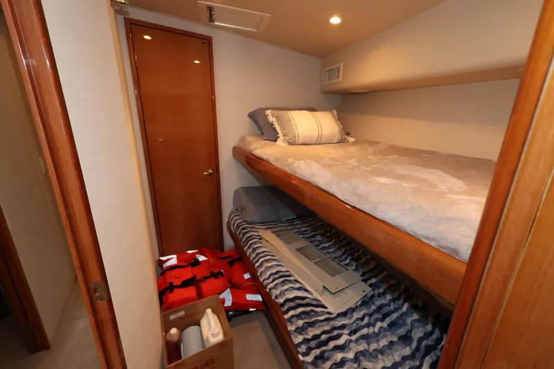  Yacht Photos Pics 2005 Viking 52 Convertible cabin with bunk beds and storage items.