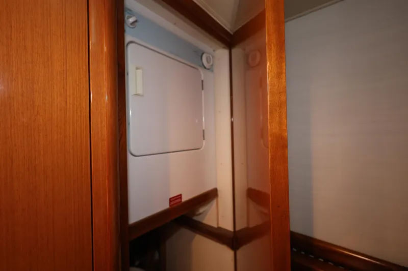  Yacht Photos Pics Laundry area inside 2005 Viking 52 Convertible yacht, featuring a compact washer and dryer.