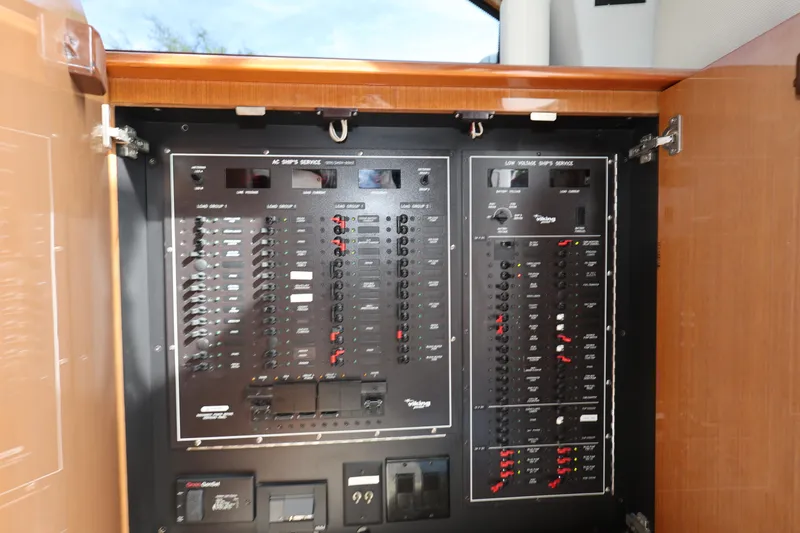  Yacht Photos Pics Electrical panel inside a 2005 Viking 52 Convertible yacht, showcasing circuit breakers and controls.