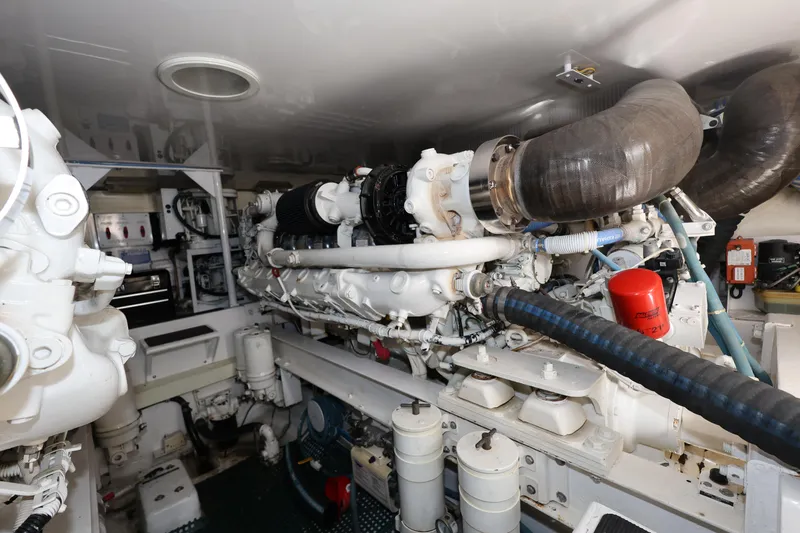  Yacht Photos Pics Engine room of a 2005 Viking 52 Convertible yacht, showcasing mechanical components and systems.
