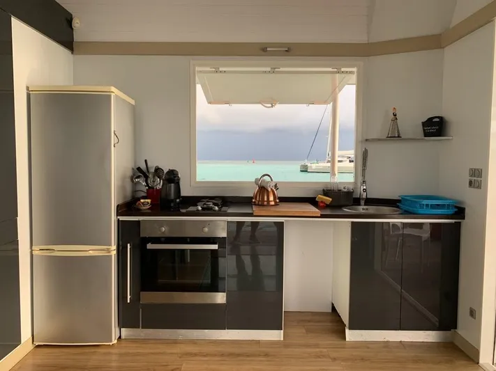 Evasion Yacht Photos Pics Modern kitchen in a 2015 Custom Aqualodge with ocean view through window.