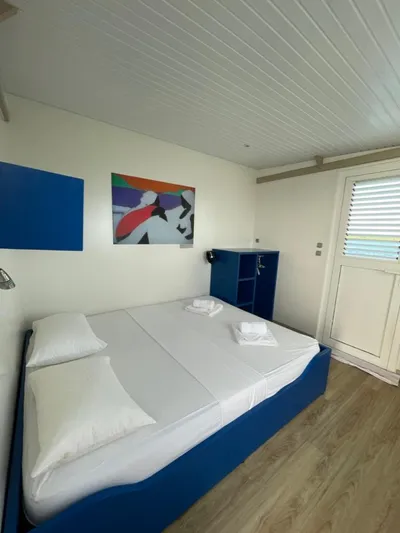 Evasion Yacht Photos Pics Modern bedroom in 2015 Custom Aqualodge with blue accents and abstract wall art.