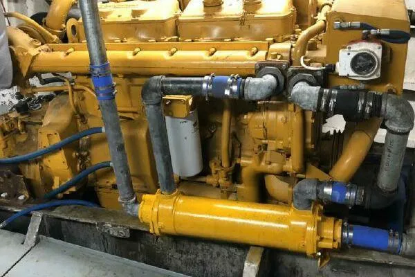 Southern Comfort Yacht Photos Pics Yellow AlumaCat 100 engine from 2000 with visible pipes and components.