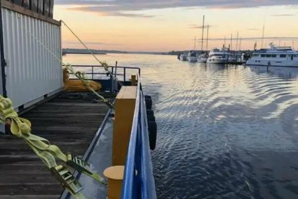 Southern Comfort Yacht Photos Pics AlumaCat 100 boat docked at sunset, 2000 model, with yachts in the background.