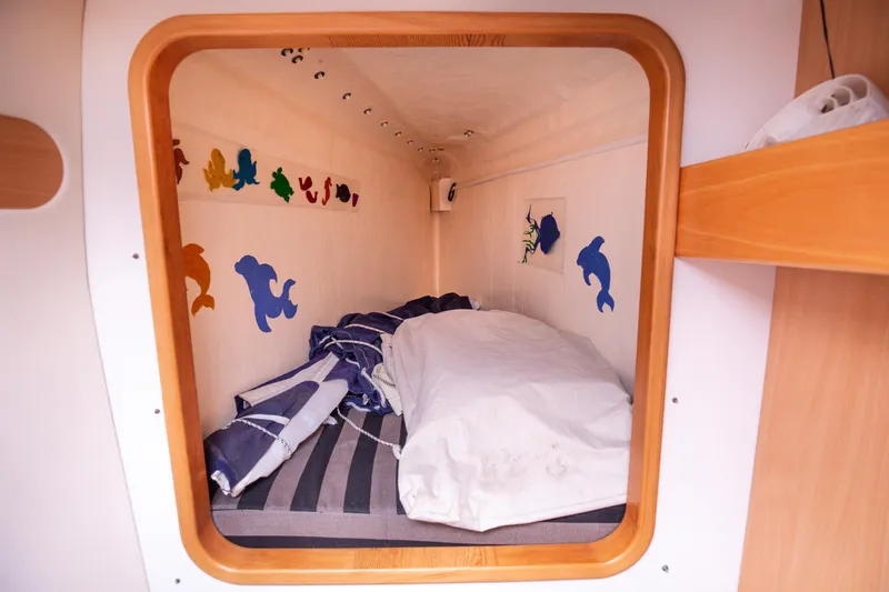  Yacht Photos Pics Cozy cabin interior of 2006 Leopard 40 catamaran with nautical decor and bedding.