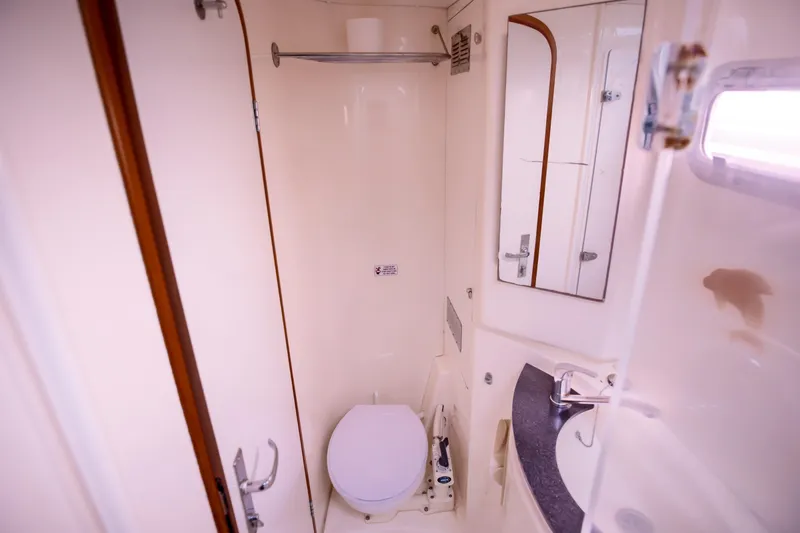  Yacht Photos Pics Bathroom interior of 2006 Leopard 40 yacht, featuring toilet, sink, and mirror.