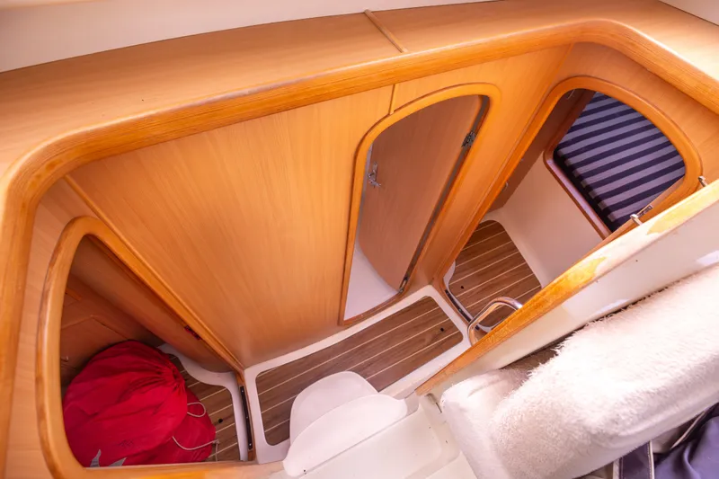  Yacht Photos Pics Interior of 2006 Leopard 40 yacht, featuring wooden cabinetry and compact bathroom space.