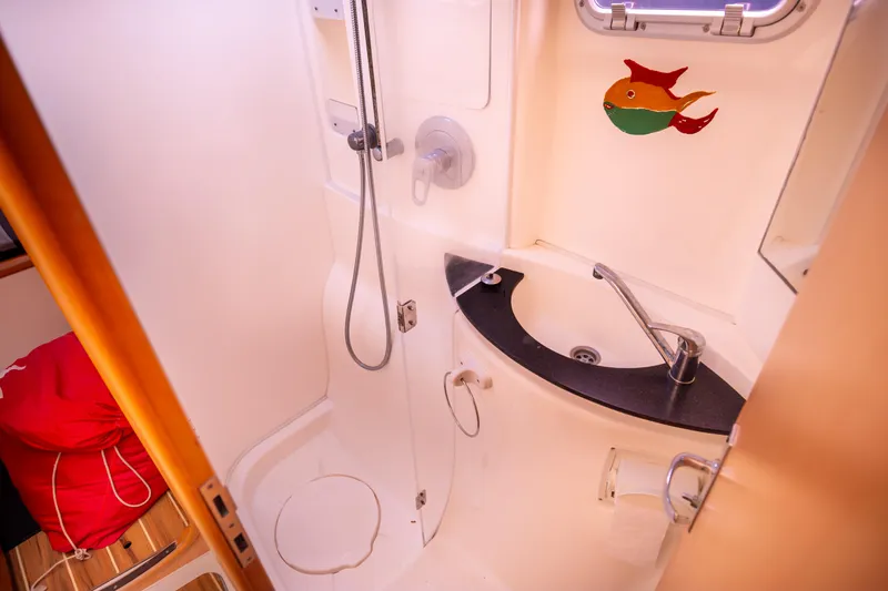  Yacht Photos Pics Compact bathroom in a 2006 Leopard 40 yacht with shower and sink.