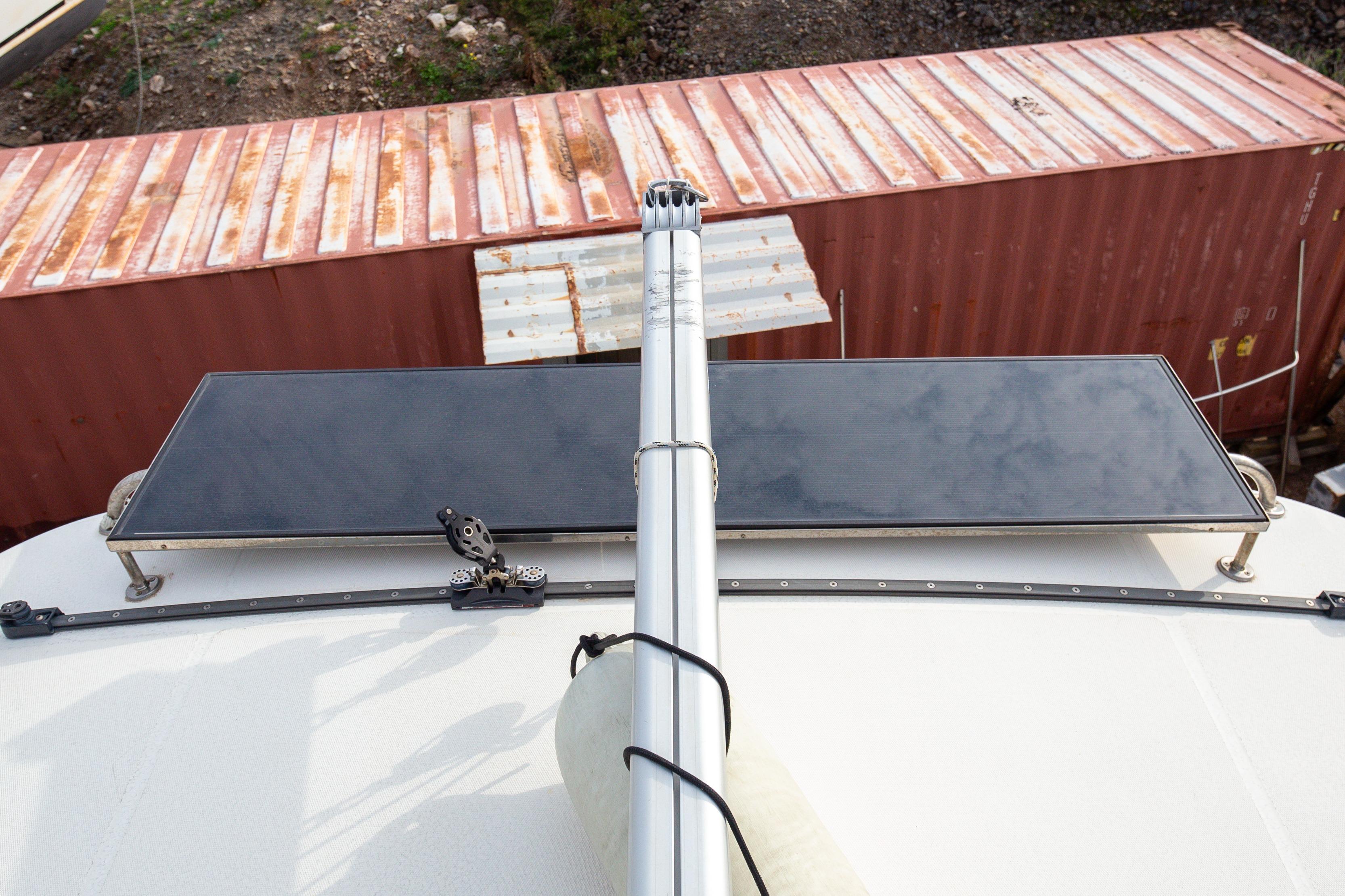 Rooftop solar panel on 2006 Leopard 40 catamaran, with shipping containers in background.