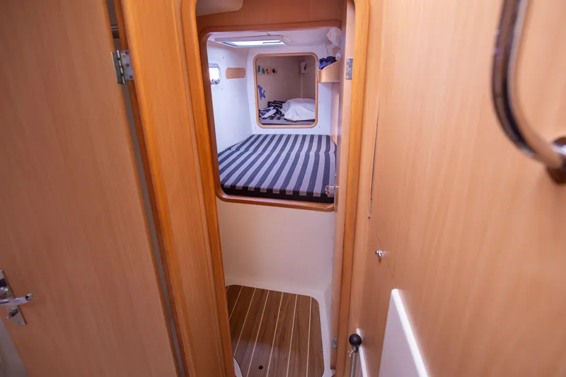  Yacht Photos Pics Interior cabin of a 2006 Leopard 40 catamaran with striped bedding.