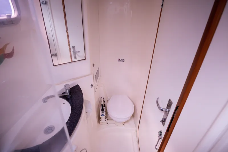  Yacht Photos Pics Compact bathroom in a 2006 Leopard 40 yacht, featuring a toilet and sink.