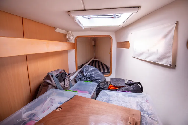  Yacht Photos Pics Interior cabin of 2006 Leopard 40 yacht with storage and striped bedding.