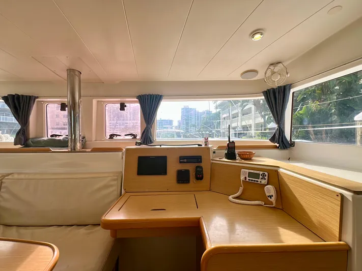 Selkie Yacht Photos Pics Interior of 2012 Lagoon 400 catamaran with navigation station and panoramic windows.