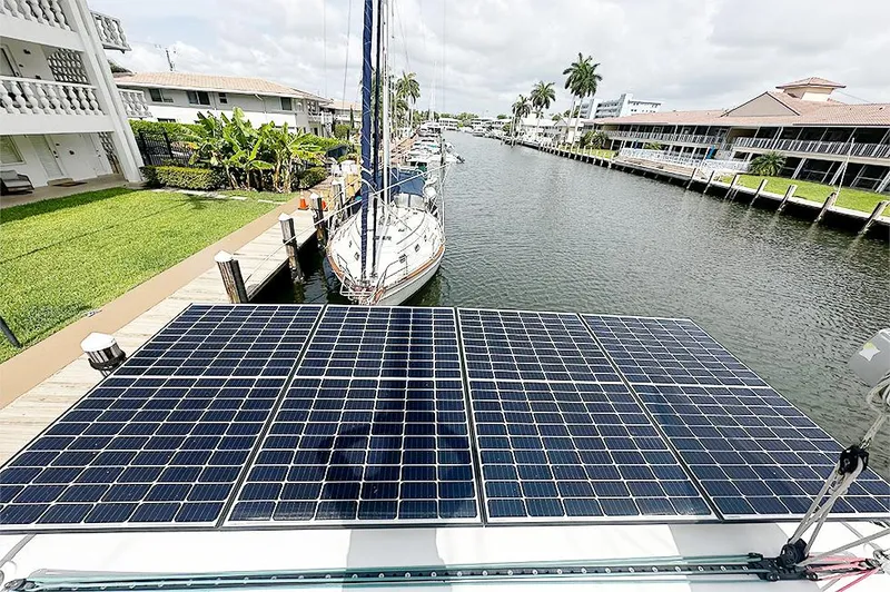 Selkie Yacht Photos Pics Solar panels on a 2012 Lagoon 400 catamaran docked in a scenic canal.