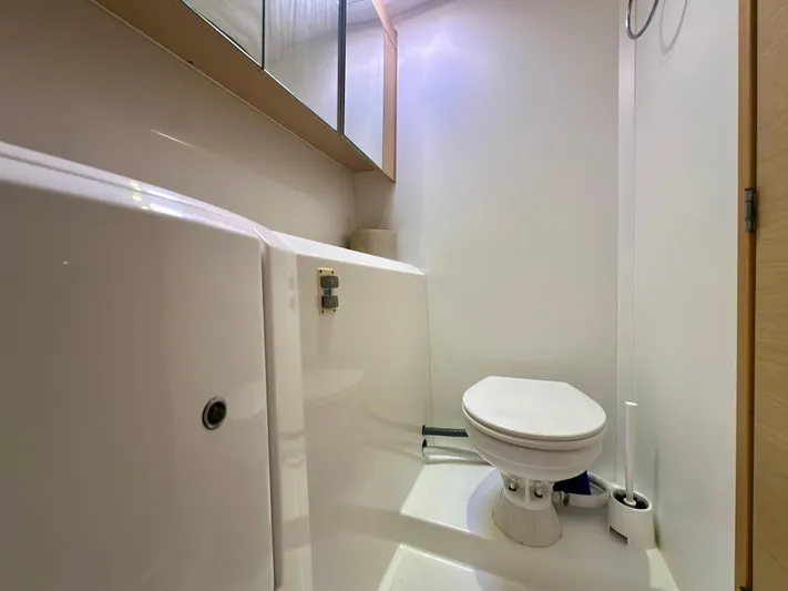 Selkie Yacht Photos Pics Bathroom interior of 2012 Lagoon 400 yacht, featuring a compact toilet setup.