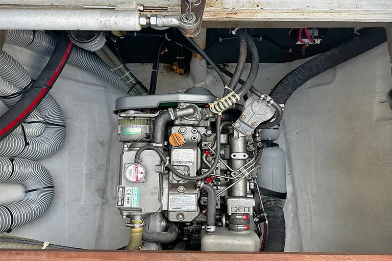 Selkie Yacht Photos Pics Engine compartment of a 2012 Lagoon 400 catamaran, showcasing mechanical components and hoses.
