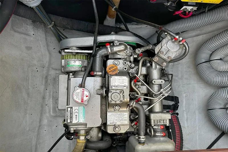 Selkie Yacht Photos Pics Engine compartment of a 2012 Lagoon 400 catamaran, showcasing mechanical components and hoses.